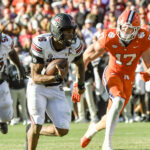 LaNorris Sellers carries the football.